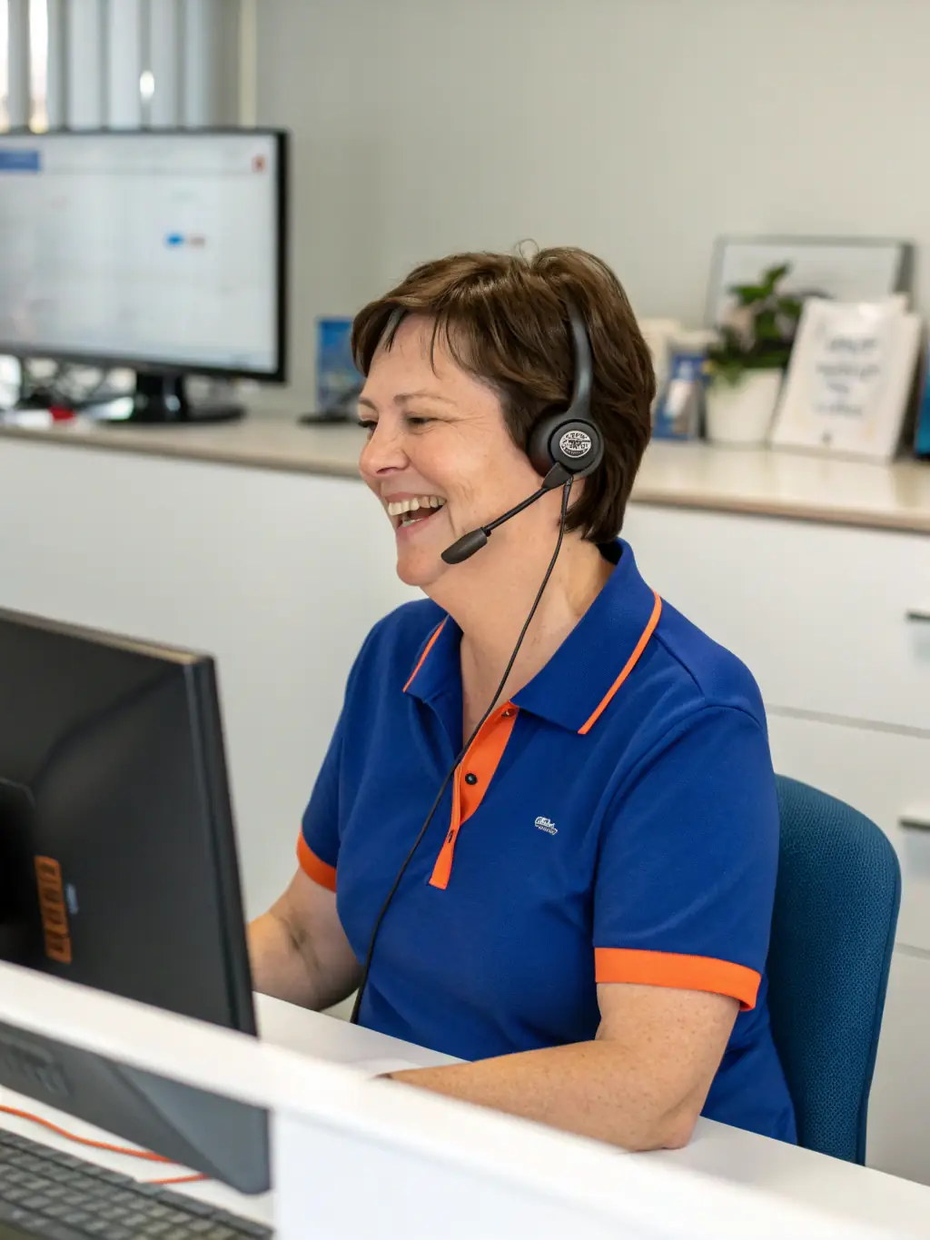 A friendly customer service representative is shown speaking on the phone in a modern office setting, highlighting the company's dedication to excellent customer support.